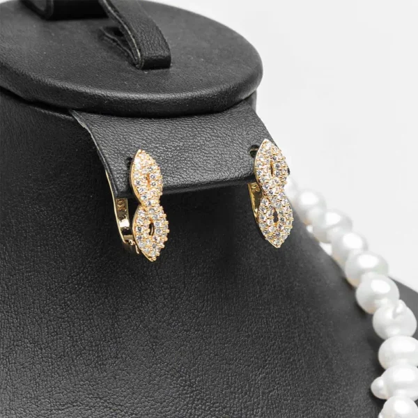 Boucles d'oreilles créoles parure L'infini doré zircons cristaux finition dorée acier inoxydable