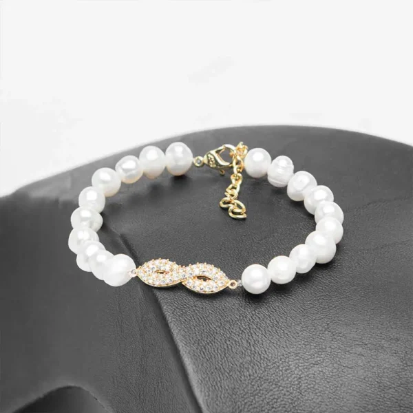 Bracelet parure L'infini doré perles d'eau douce symbole infini zircons finition dorée